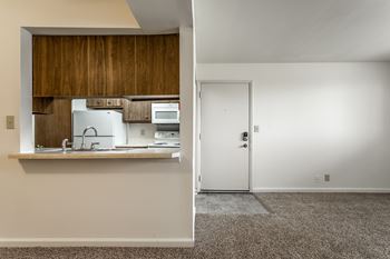 A kitchen with white appliances and a white door at Bay Pointe Apartments, Lafayette, IN